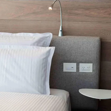 Pullman Sydney Airport Hotel Exterior photo A bed with a lamp